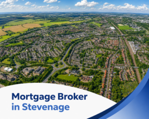 Promotional graphic for a mortgage broker in Stevenage, featuring a bright summer aerial view of the town with residential neighbourhoods, roads and green spaces under a blue sky with realistic clouds. A curved white banner overlays the lower part of the image, with the title “Mortgage Broker in Stevenage” shown in two branded blue tones, alongside sweeping blue accent shapes on the right. Mortgage Broker in Stevenage