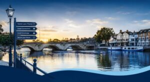 Mortgage Adviser in Staines-Upon-Thames near the River Thames, featuring Staines Bridge, waterfront buildings and local signposts.