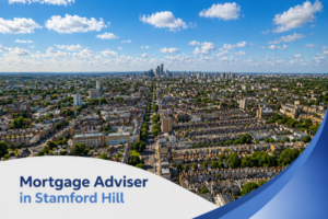 A bright, high-resolution aerial view of a densely built residential area in Stamford Hill on a clear summer’s day, featuring rows of terraced houses, tree-lined streets, and a distant city skyline under a vivid blue sky with realistic scattered clouds. A clean, curved white and blue graphic overlay sits at the bottom, displaying the text “Mortgage Adviser in Stamford Hill” in a modern, bold font, creating a polished and professional promotional design.
