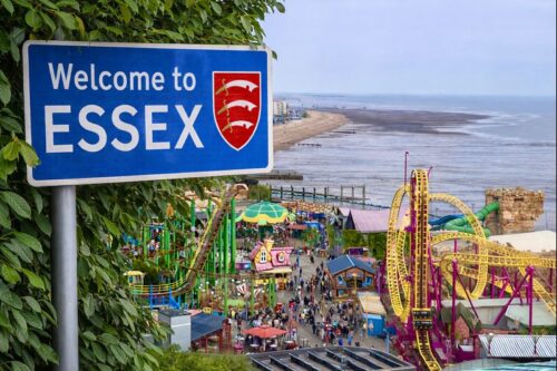 Welcome to Essex sign surrounded by green foliage blended into a coastal Essex scene, featuring Southend seafront and Adventure Island attractions along the shoreline under a clear sky.
