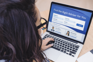 Woman using a laptop to search for a mortgage broker, with a screen showing a search interface and the message “Find the Right Adviser for You” in blue branded styling. Mortgage Broker Reviews UK