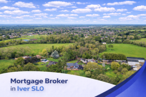 Bright aerial view of Iver SL0 on a sunny summer’s day, featuring detached homes, open green fields, and tree-lined surroundings under a blue sky with natural, realistic clouds, with a clean curved banner at the bottom displaying the text “Mortgage Broker in Iver SL0”.