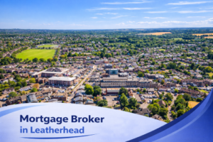 Bright summer aerial view of Leatherhead showing the town centre, residential streets and surrounding green countryside under a clear blue sky, with a white and blue curved banner at the bottom displaying the text “Mortgage Broker in Leatherhead”.