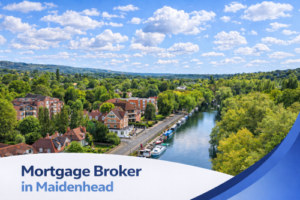 A bright summer aerial view of Maidenhead showing the River Thames with boats moored along the riverbank, tree-lined streets and red brick homes surrounded by lush green countryside under a blue sky with natural scattered clouds. A curved white and blue banner at the bottom displays the text “Mortgage Broker in Maidenhead”.
