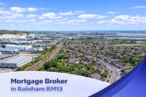A bright, high-resolution aerial view of Rainham RM13 on a sunny summer day, featuring residential streets, industrial buildings, and waterways under a vivid blue sky with realistic scattered clouds. A clean curved white and blue banner overlays the bottom of the image with the text “Mortgage Broker in Rainham RM13” in a modern professional font.