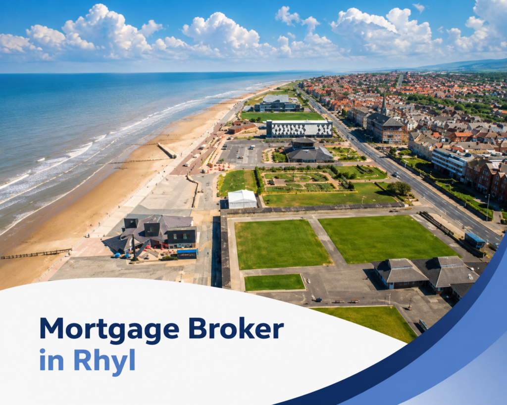 Promotional graphic for a mortgage broker in Rhyl, showing a bright summer aerial view of Rhyl’s seafront with sandy beach, blue sea, promenade, green open spaces, and rows of coastal buildings under large white clouds. A white curved banner overlays the bottom left with the text “Mortgage Broker in Rhyl” in two blue brand tones, while layered dark and light blue swooshes frame the lower right corner.