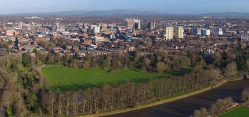 Wide real aerial view of Preston in Lancashire, showing Avenham Park, the River Ribble, nearby homes, roads and green space close to the city centre. Why Move to Lancashire