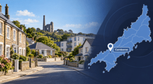 Mortgage Broker in Camborne hero image showing a Cornwall street scene with varied homes, local mining heritage landmark, and a map pin marking Camborne